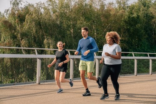three people running outside