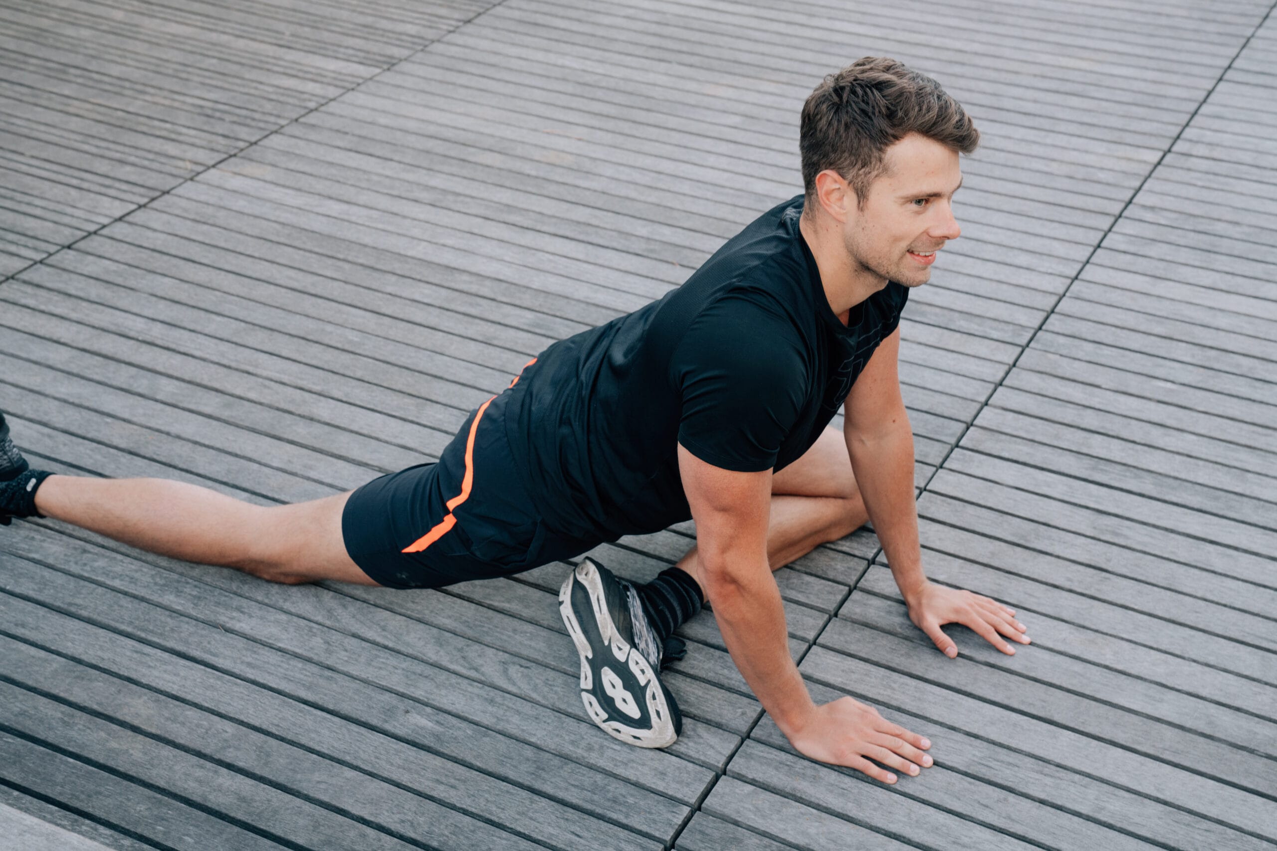 man stretching legs on floor