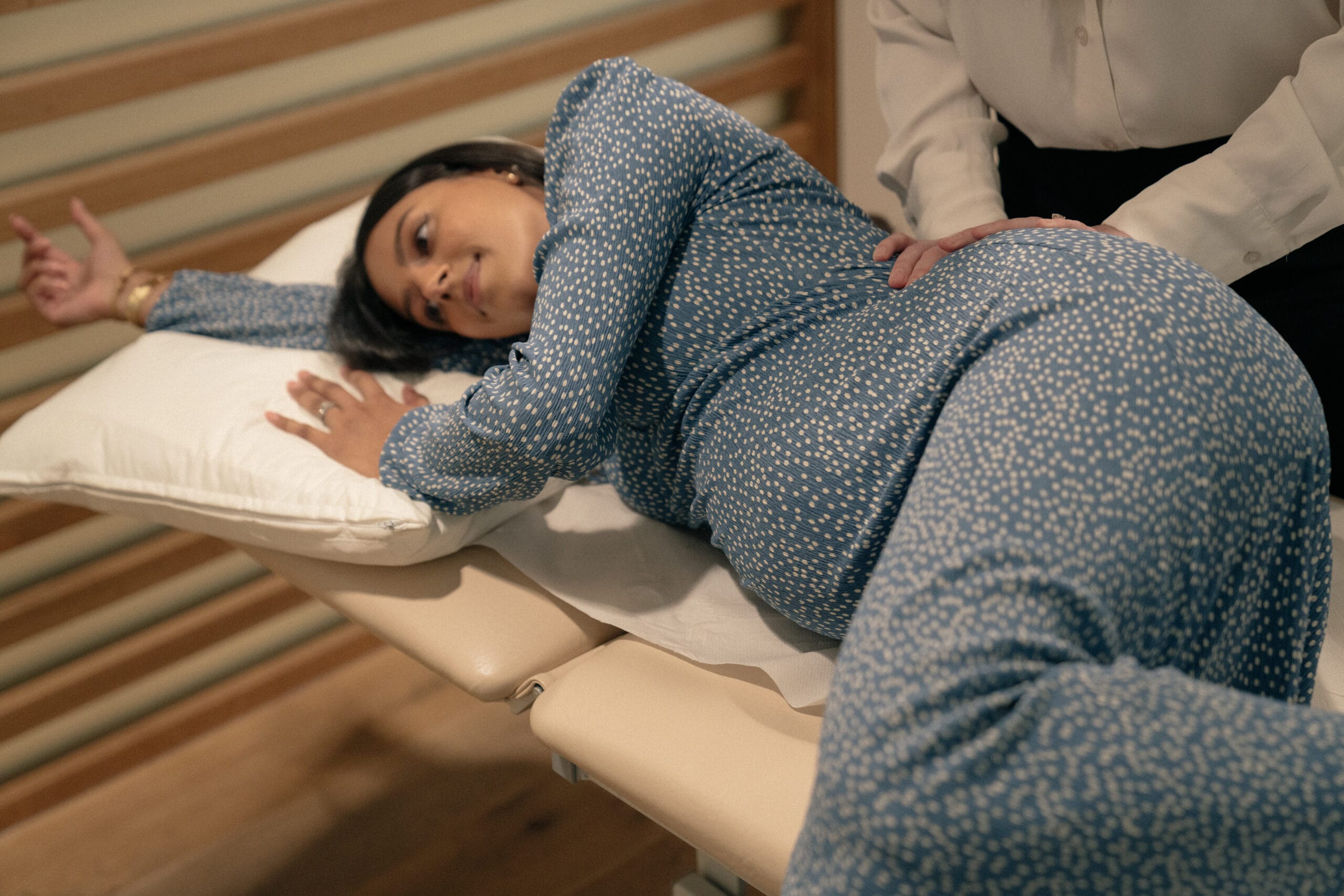 pregnant women laying on appointment bed