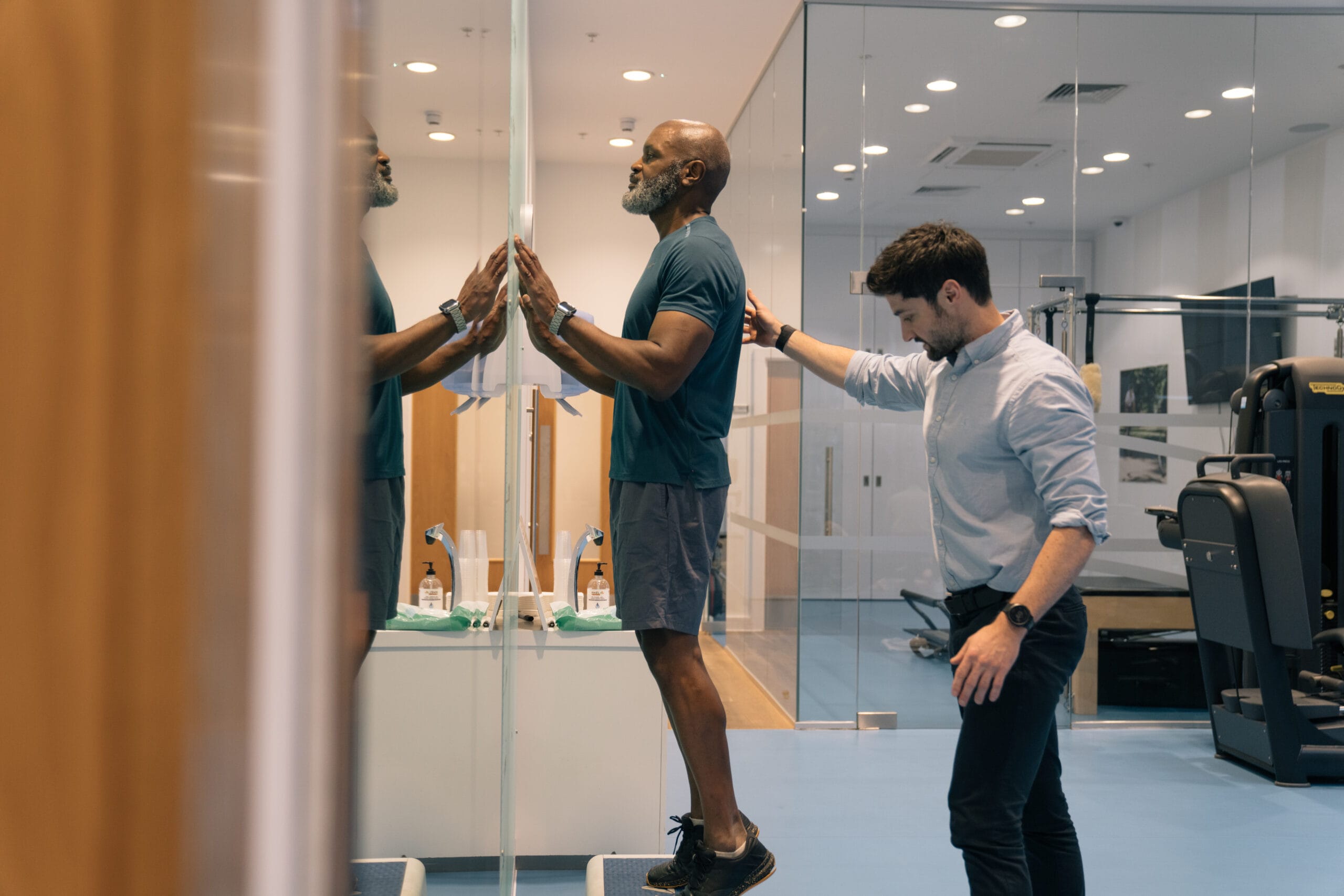 clinician assisting patient in recovery gym