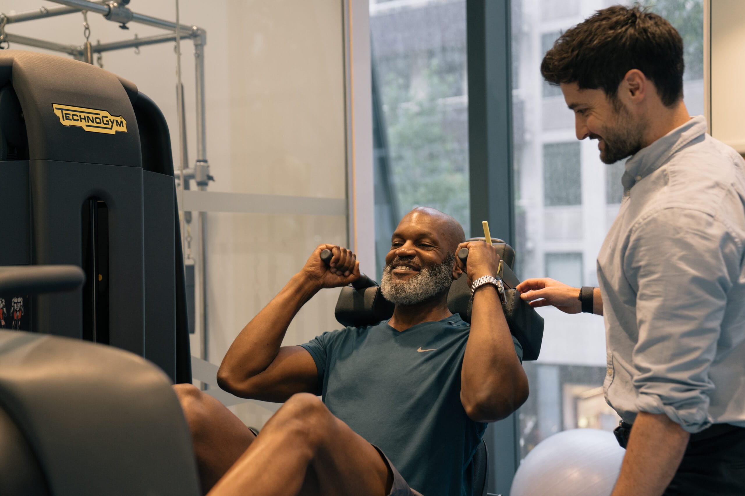 clinician supporting patient in recovery gym