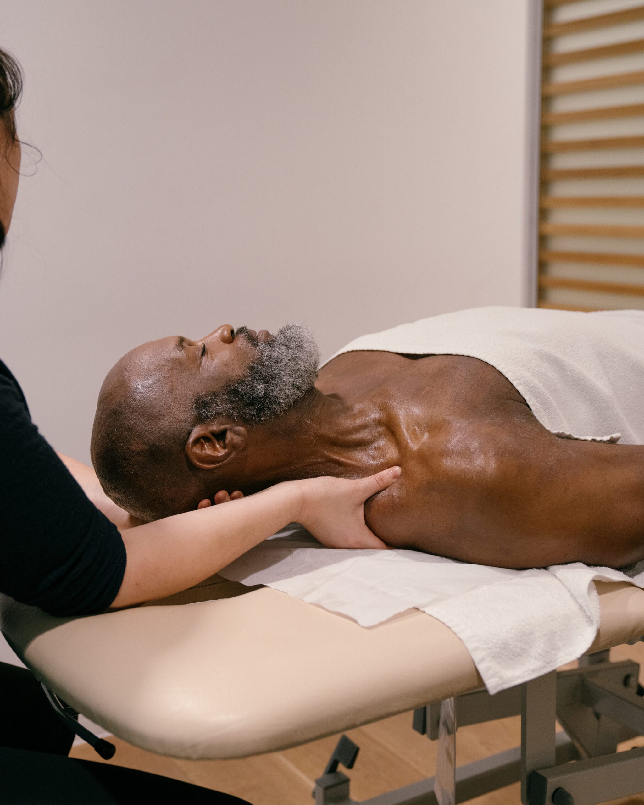 Patient laying face up on bed in Soft tissue therapy