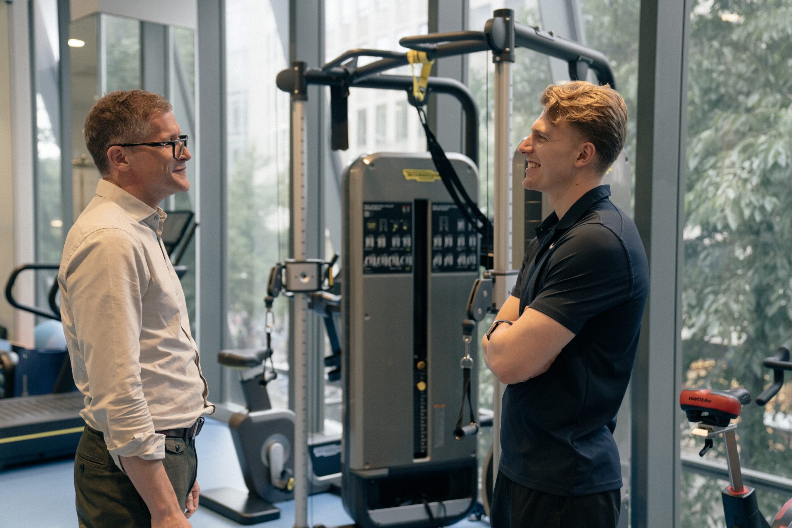 two men talking in recovery gym