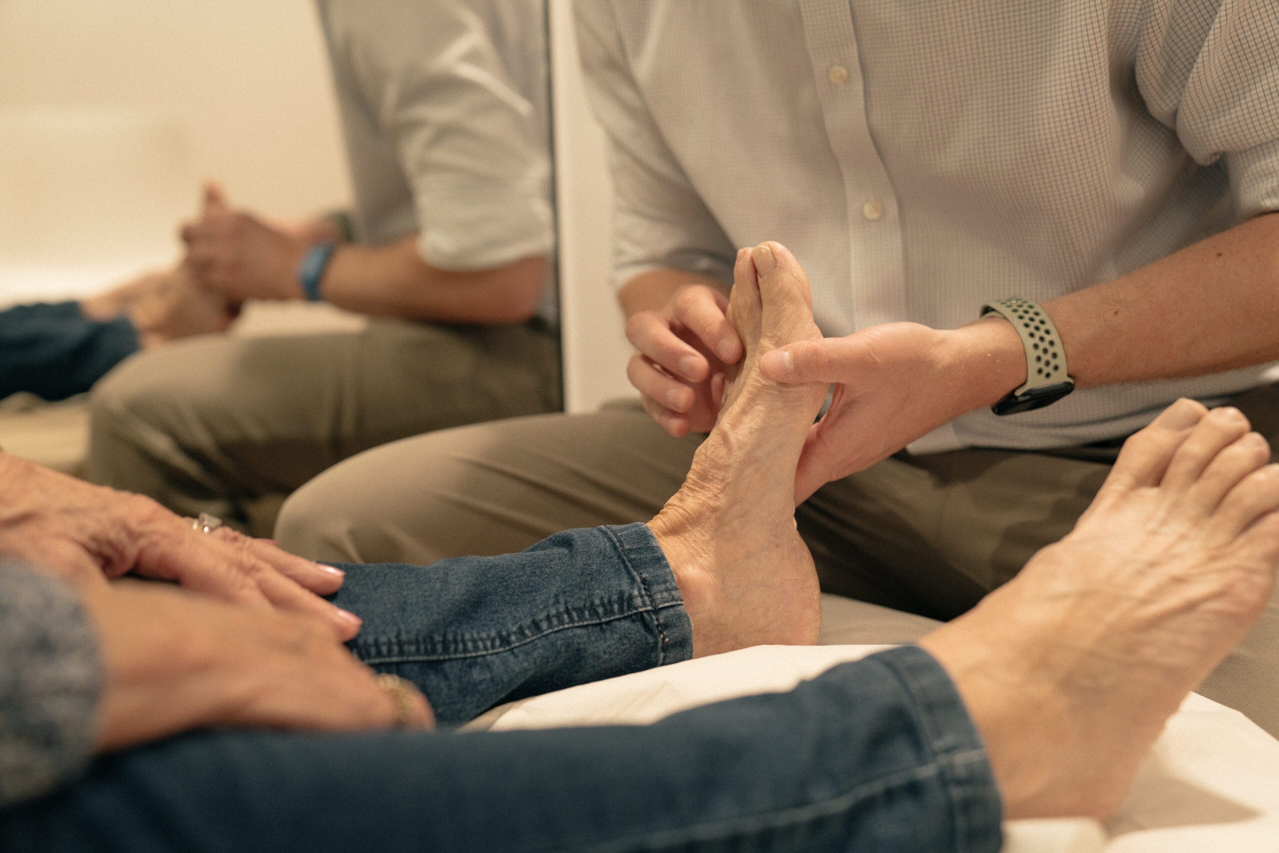 Close up on clinician assessing patient's feet