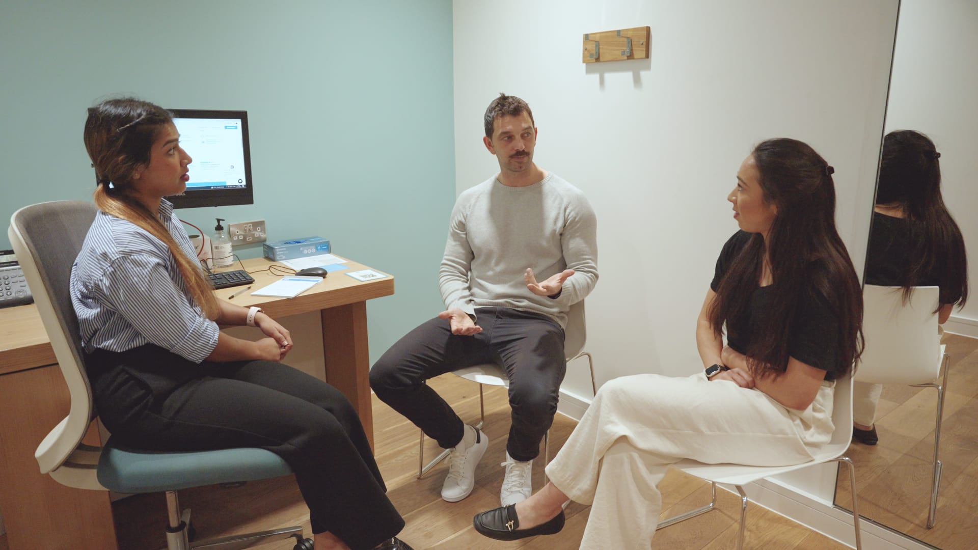three people in appointment office