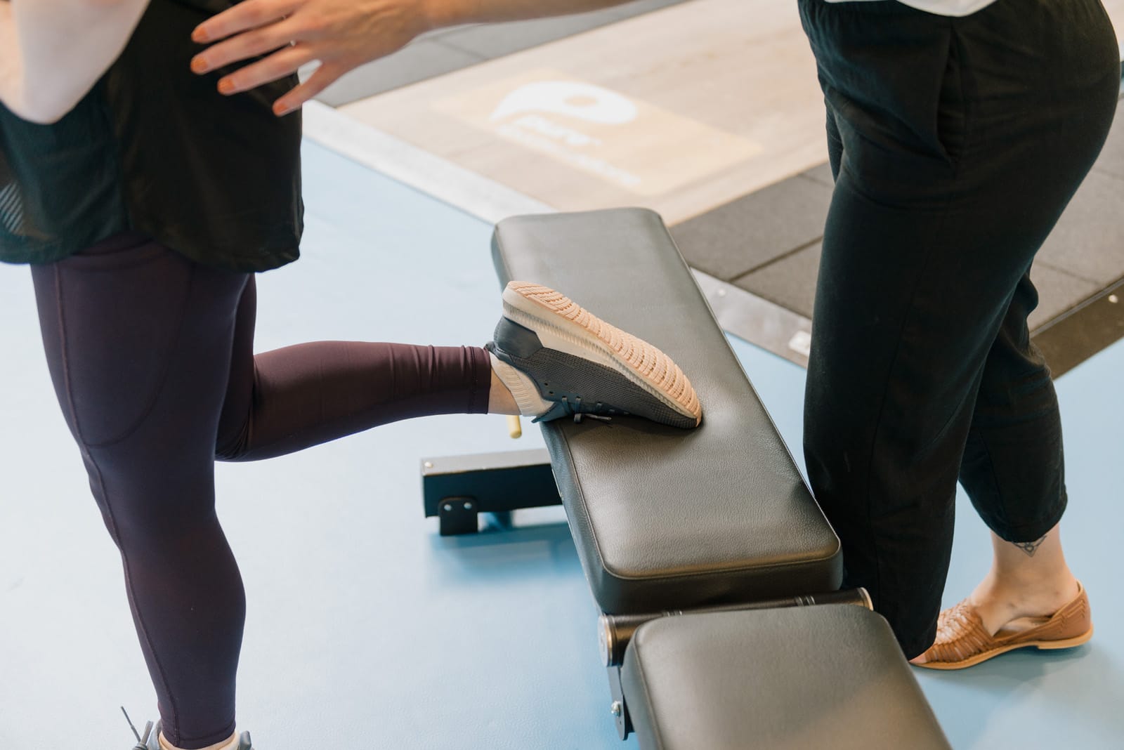 foot upon exercise bench being supported