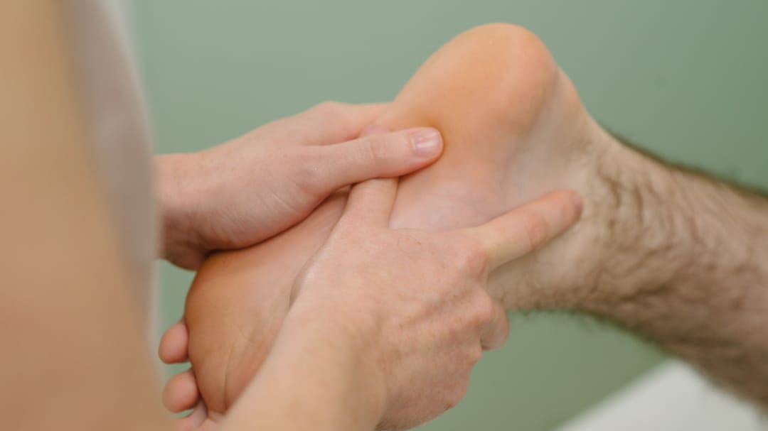 Hands assessing foot for podiatry