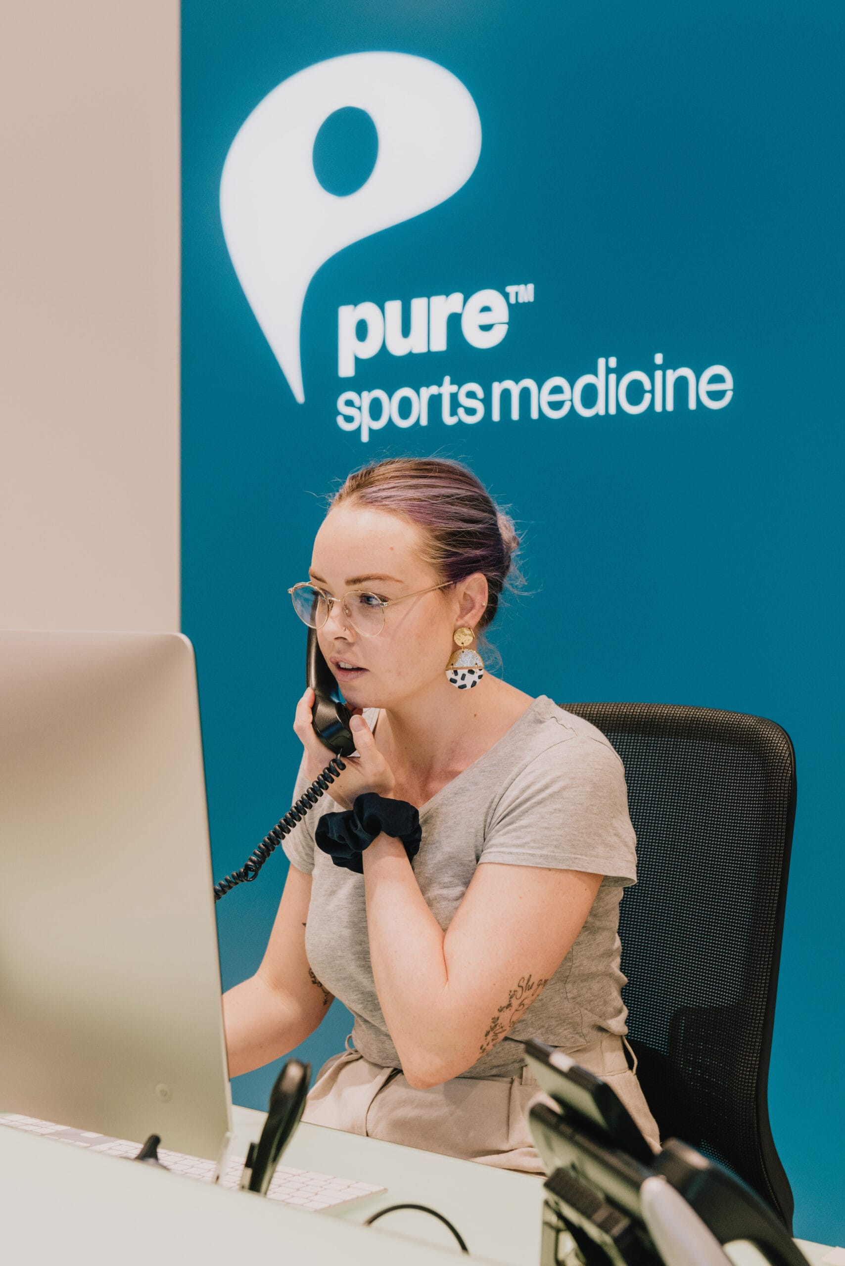 Receptionist on the phone at Pure Sports Medicine